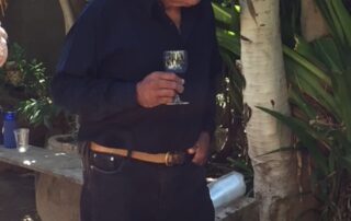 Man in cowboy hat holding a wine glass