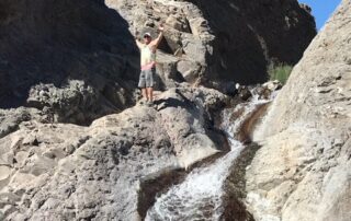 Person standing at the top of a waterfall