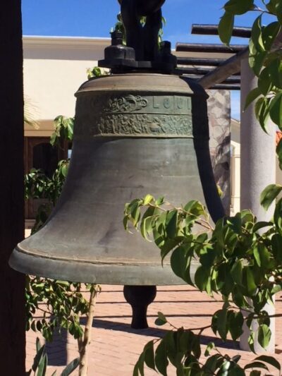 Large antique bell hanging outdoors