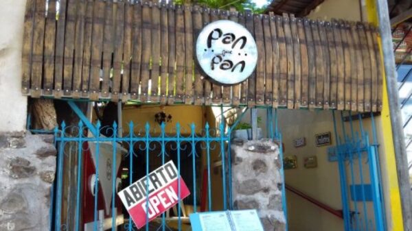 Pan que Pan bakery entrance in Loreto with blue iron gate and abierto (open) sign